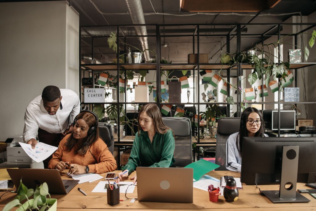 Business professionals interacting with customers and analyzing engagement metrics to support brand growth